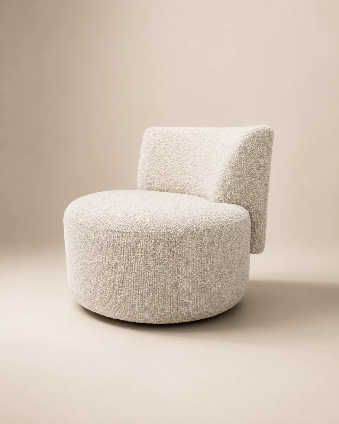 The Odette swivel chair — a plump cylindrical bouclé base cradling a gently reclined back.